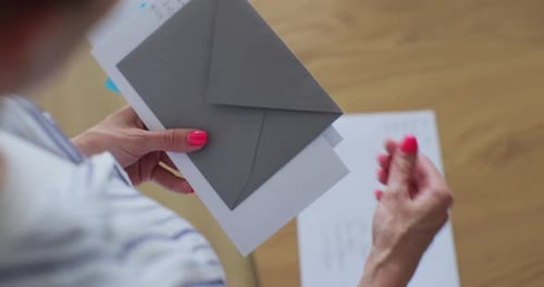 Woman Holds Envelopes with Addresses in Handwriting
