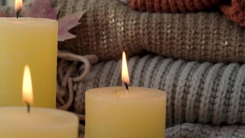 Candles Burning near Soft Knitwear and Star Anise