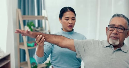 Therapist Assisting Senior Man with Arm Exercises