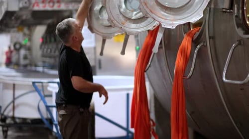 Man Supervising Textile Dyeing Process at Factory