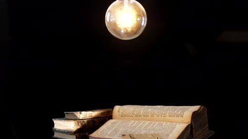 Vintage Books Illuminated by Warm Light Bulb