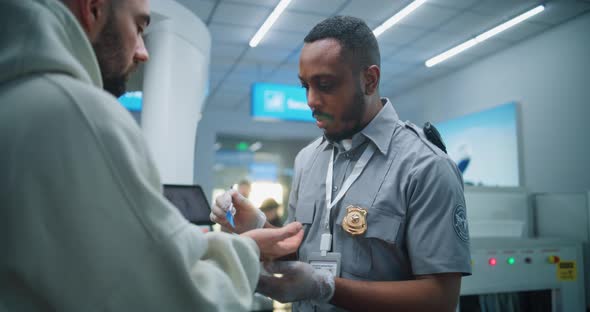 Airport Terminal Security Officer Conducts TSA Hand Swab Screening with ...