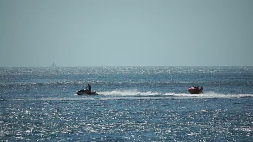 Jet Ski Pulling Tube Across Sea