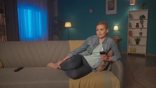 Woman Relaxing on Couch With Glass of Wine