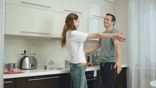 Happy Couple Hugging and Embracing in Modern Kitchen