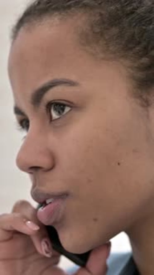 Young Woman Talking on Mobile Phone, Vertical Video