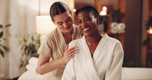 Women, customer and beauty therapist at spa with smile or satisfied for massage and body wraps