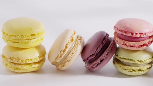 An Array of Colorful Macarons is Arranged in a Row on a White Background