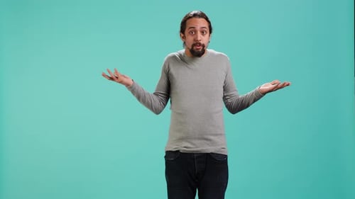 Man Shrugs with Hands Up on Green Screen