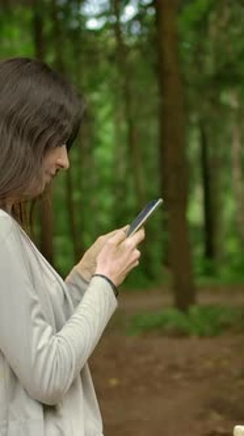 Vertical of The Girl Artist Completed Art Work on Her Painting and Chatting in Her Smartphone
