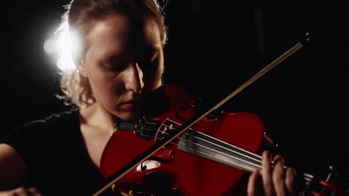 Rain on Stage of Theatre Beautiful Woman Musician Playing Violin in Darkness Inspiration and Talent