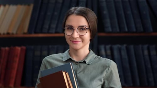 Female Smiling Student Teacher Academic Posing at Library with Books Educational Bookshelf Interior