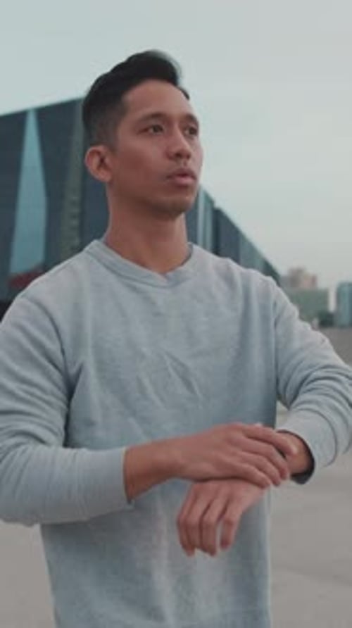 Man Warming Up and Jogging in the City