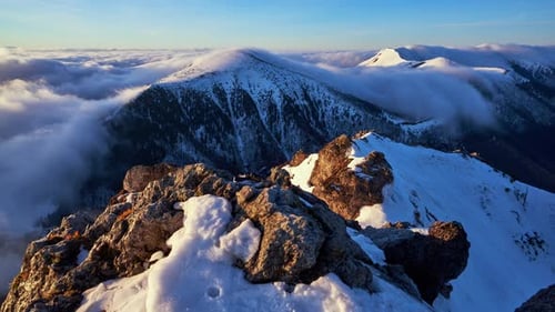 Time Lapse Shot of Clouds Below Mountain Peak in Winter Shortly After Sunrise