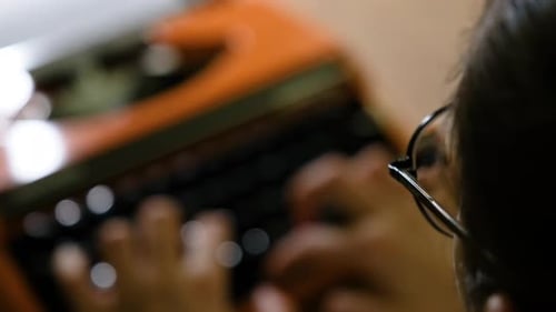 Writing letters with orange retro vintage typewriter