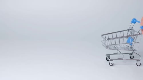 Shopping Toy Trolley on White Background with Some Copy Space Online Shopping Concept Closeup Slow