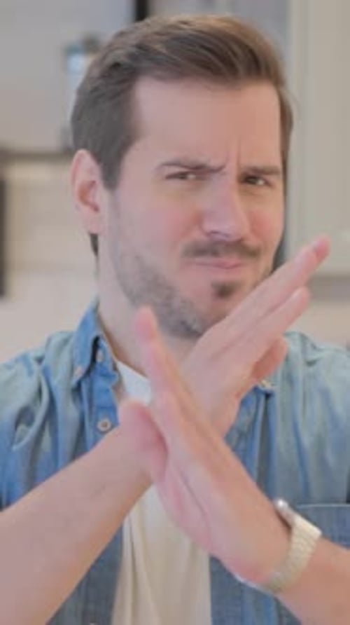 Man Gesturing a No Sign with Crossed Arms
