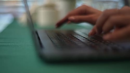 Woman's Hands Typing on Laptop Keyboard Close Up