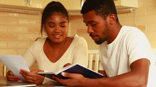 African American Couple Managing Finances Bank and Using Laptop at Kitchen