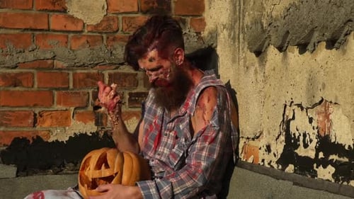 Halloween Zombie Man with Halloween Pumpkin Creepy Man with Bloody Scars Halloween Close Up Face Man