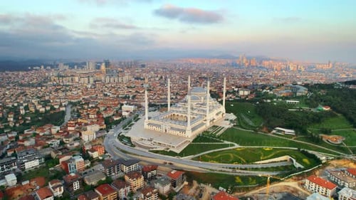 Aerial drone view of Istanbul at sunset, Turkey. Camlica mosque with multiple buildings around, gree