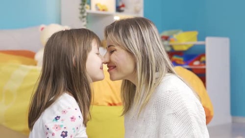 Affectionate Mother and Child Nuzzle and Embrace