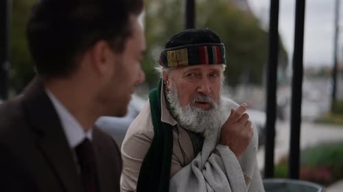 Senior Man Talking With a Young Adult