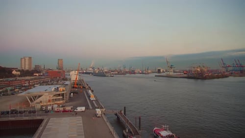 extraordinary time lapse shot of the Port of Hamburg with an aircraft carrier approaching at sunset