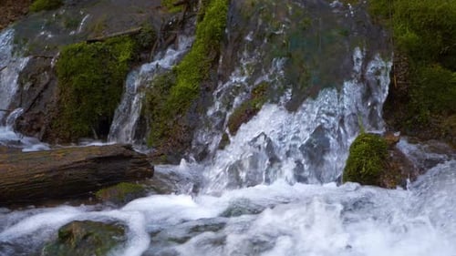 Close-up waterfall, water falling and bubbling slow motion