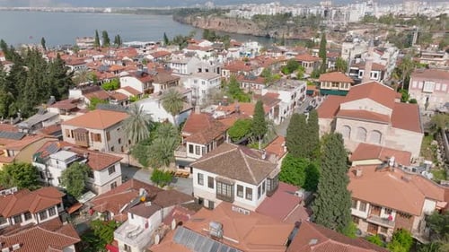 Aerial View of Houses with Tiled Roofs Sehzade Korkut Mosque with Minaret Housing Estate at Sea