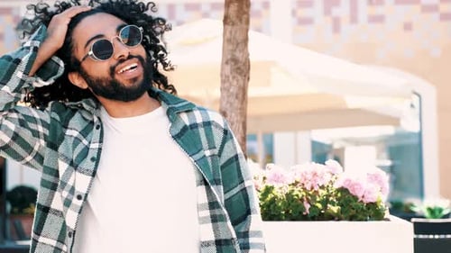 Attractive Man Posing in Sunglasses on City Street