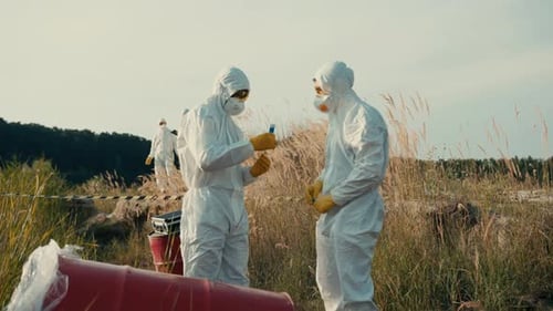 Workers in Hazmat Suits Collect Samples in Field