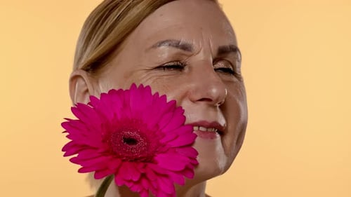 Close Up of Mature Womans Face with Flower Detail