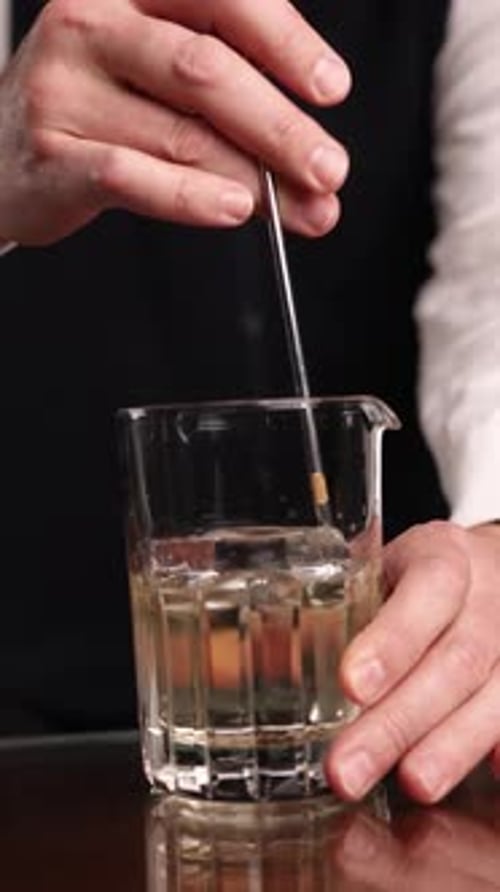 the bartender prepares a popular cocktail at the bar
