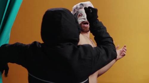 Hooded Figure Startles Man Wearing a Face Mask