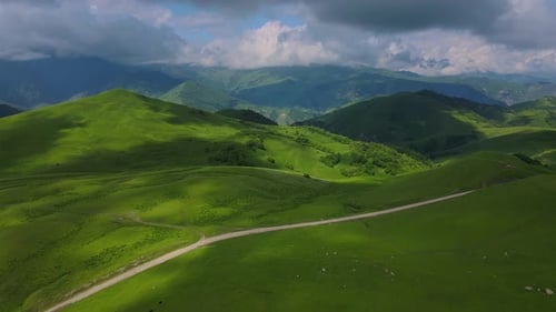 Actoprak's Green Mountain Pass Aerial View Day's Charm Cloud Embrace Majestic Mountain Pass Scenic