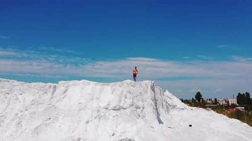 Professional bodybuilder posing outdoors. Concept of beautiful healthy body. Aerial view