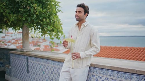Smiling Man Holding Flower Standing on Cloudy Viewpoint Zoom on Guy Looking Sea