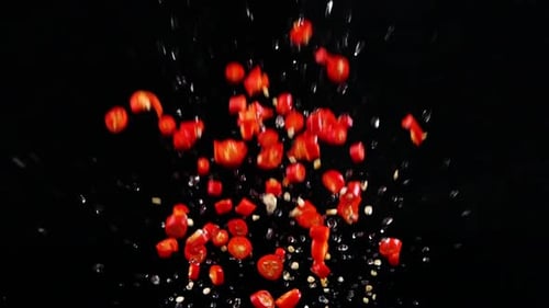 Sliced Red Chili Peppers Splashing Upward