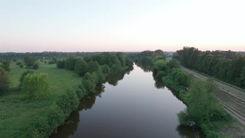 Low drone flight over the river at sunset. Drone Shot 4K.