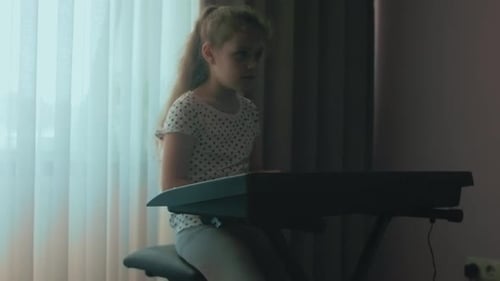 Child Plays Electronic Keyboard at Home