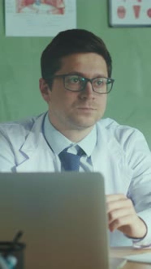 Doctor Working at Desk in Medical Office