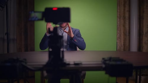 A Professional Speaker is Ready on a Green Screen Set for Effective Audience Engagement