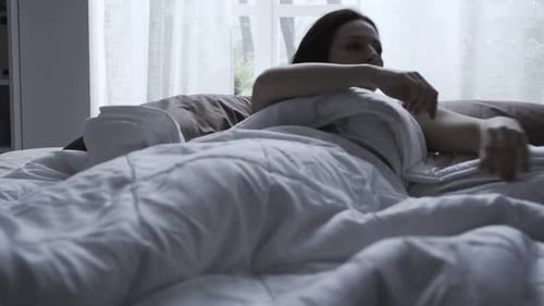 Woman Wakes Up Suddenly and Looks at Alarm Clock