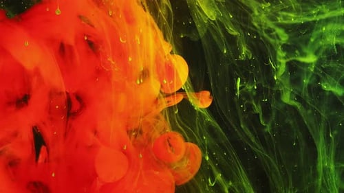Colorful Rainbow Paint Drops From the Bottom Mixing in Water Closeup