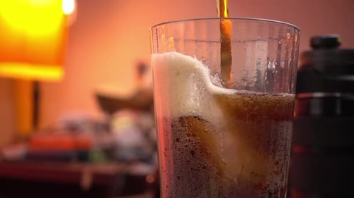 Pouring Soda into Glass with Ice