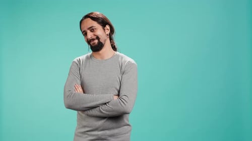 Smiling Young Man with Arms Crossed, Studio Shot