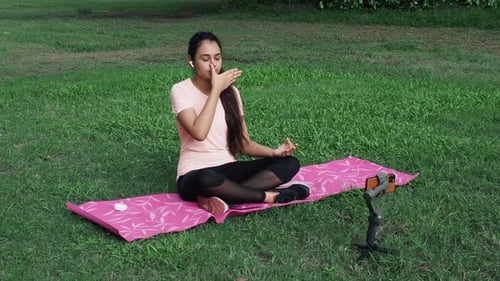 Young Woman Doing Yoga in Urban Park