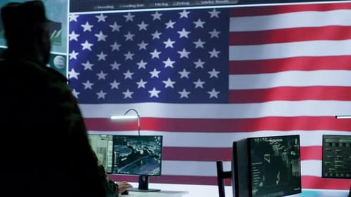 US Military Officer Supervising Threat Detection Activity in High Tech Office