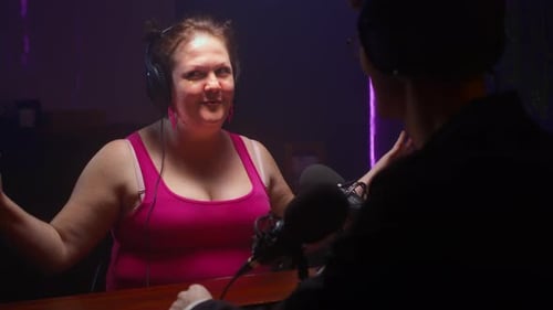 Woman Interviewed in Dark Podcast Studio